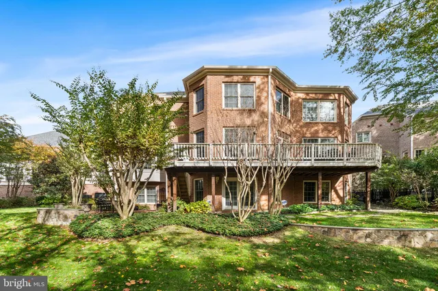 a backyard of a house with a fountain table and chairs