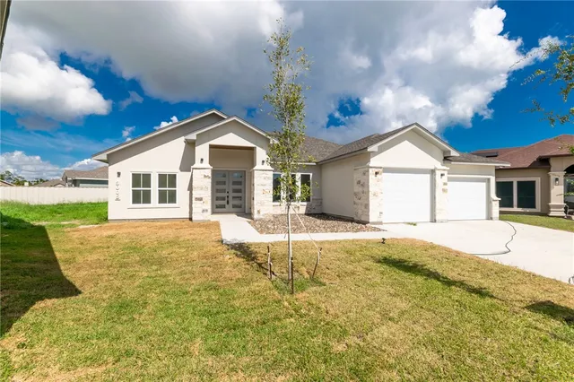 a view of a white house with a yard