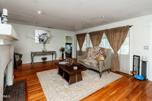 a bathroom with a sink a mirror and a painting on the wall