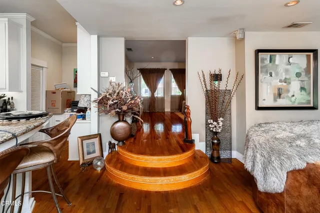 a front view of a house with a garden and trees