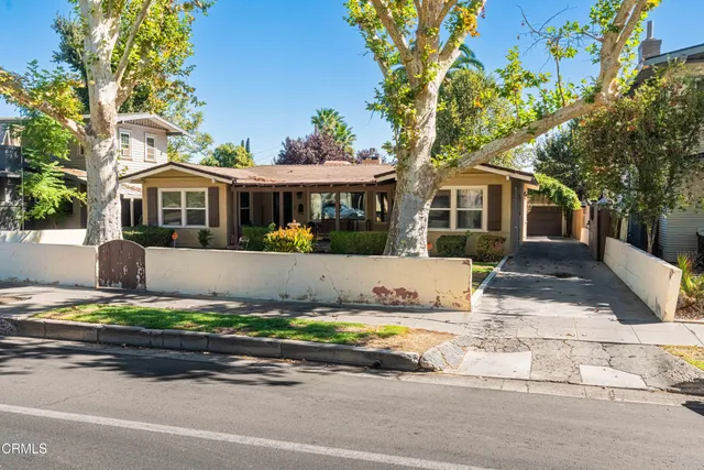 a living room with fireplace furniture and a flat screen tv