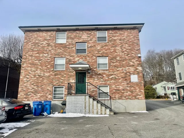 a brick building with a street sign on the side of it