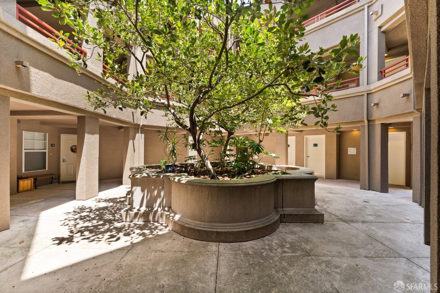280 Caldecott Lane, Unit 101 Oakland, CA 94618 - Photo 1 of 32 a view of a patio with table and chairs and potted plants