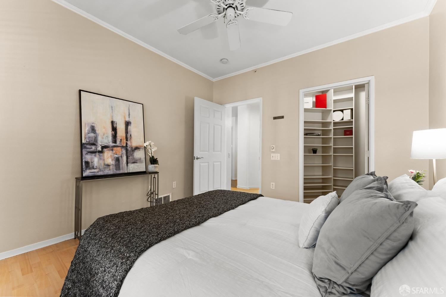 280 Caldecott Lane, Unit 101 Oakland, CA 94618 - Photo 23 of 32 a bedroom with a bed and a chandelier