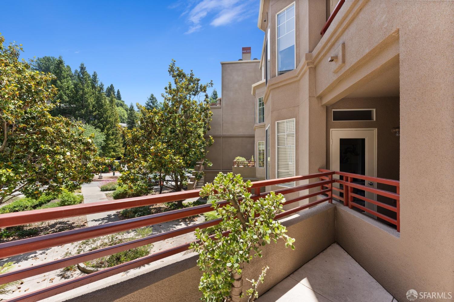 280 Caldecott Lane, Unit 101 Oakland, CA 94618 - Photo 26 of 32 a view of a house with a large windows and flower plants