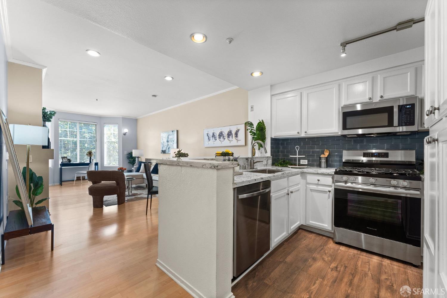 280 Caldecott Lane, Unit 101 Oakland, CA 94618 - Photo 3 of 32 a kitchen with a sink cabinets and stainless steel appliances
