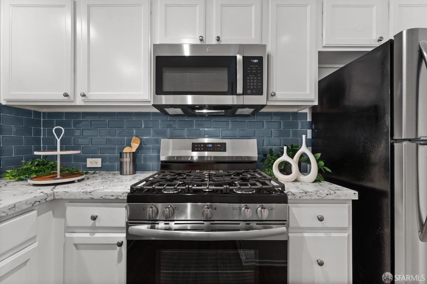 280 Caldecott Lane, Unit 101 Oakland, CA 94618 - Photo 7 of 32 a kitchen with stainless steel appliances granite countertop a stove and a microwave