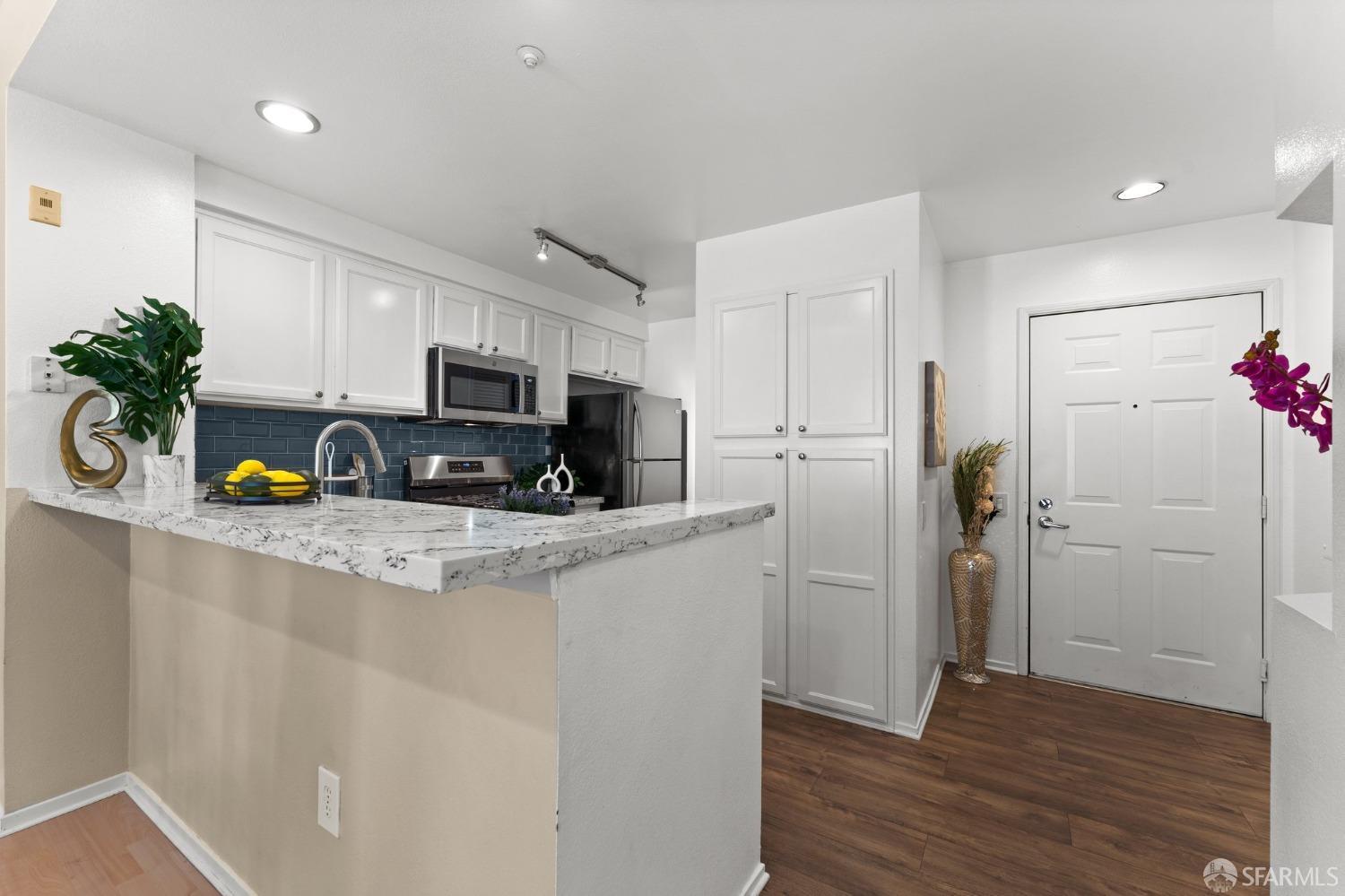 280 Caldecott Lane, Unit 101 Oakland, CA 94618 - Photo 10 of 32 a kitchen with a refrigerator a stove and cabinets