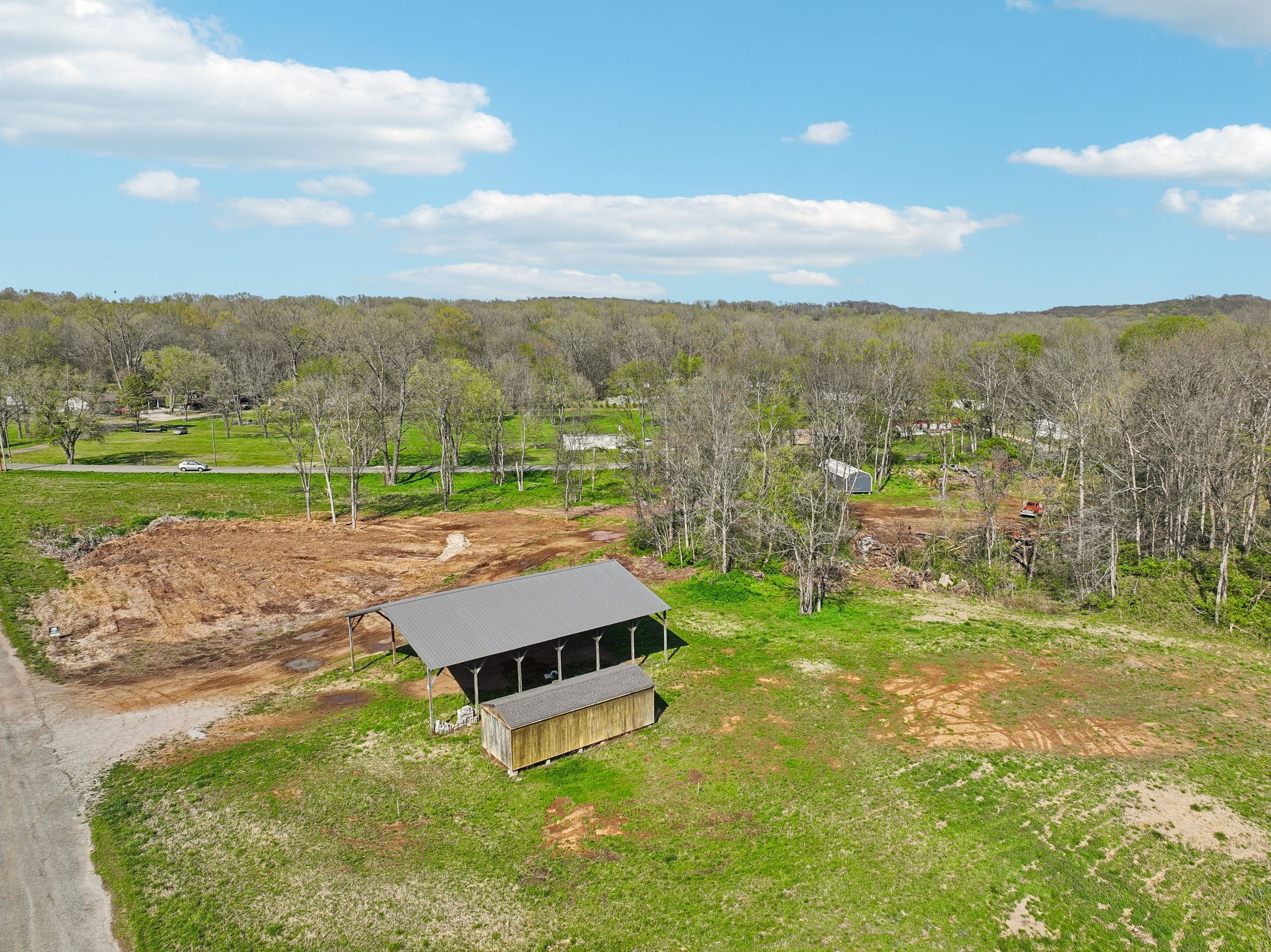 7919 Golf Club Road Mount Pleasant, TN 38474 - Photo 3 of 16 a view of a big yard with an buildings and trees