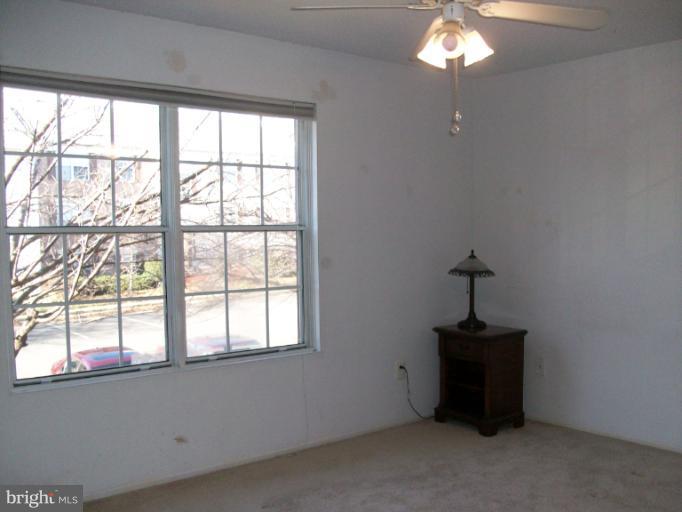 115 Fort Evans Road Southeast, Unit C Leesburg, VA 20175 - Photo 3 of 10 a view of an empty room with a window