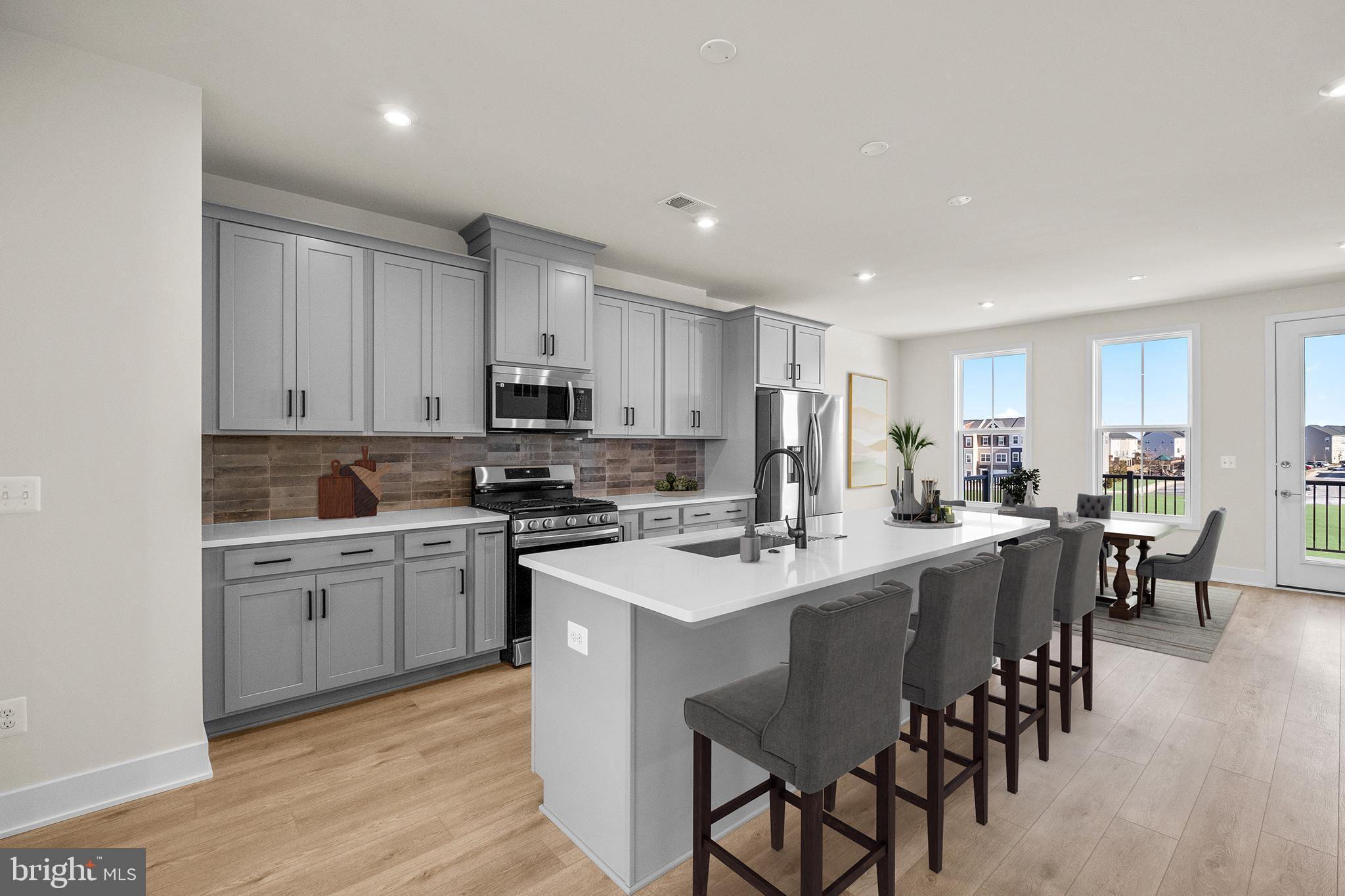 115 Galaxy Place Stephenson, VA 22656 - Photo 4 of 19 a kitchen with appliances a sink a table and chairs in it