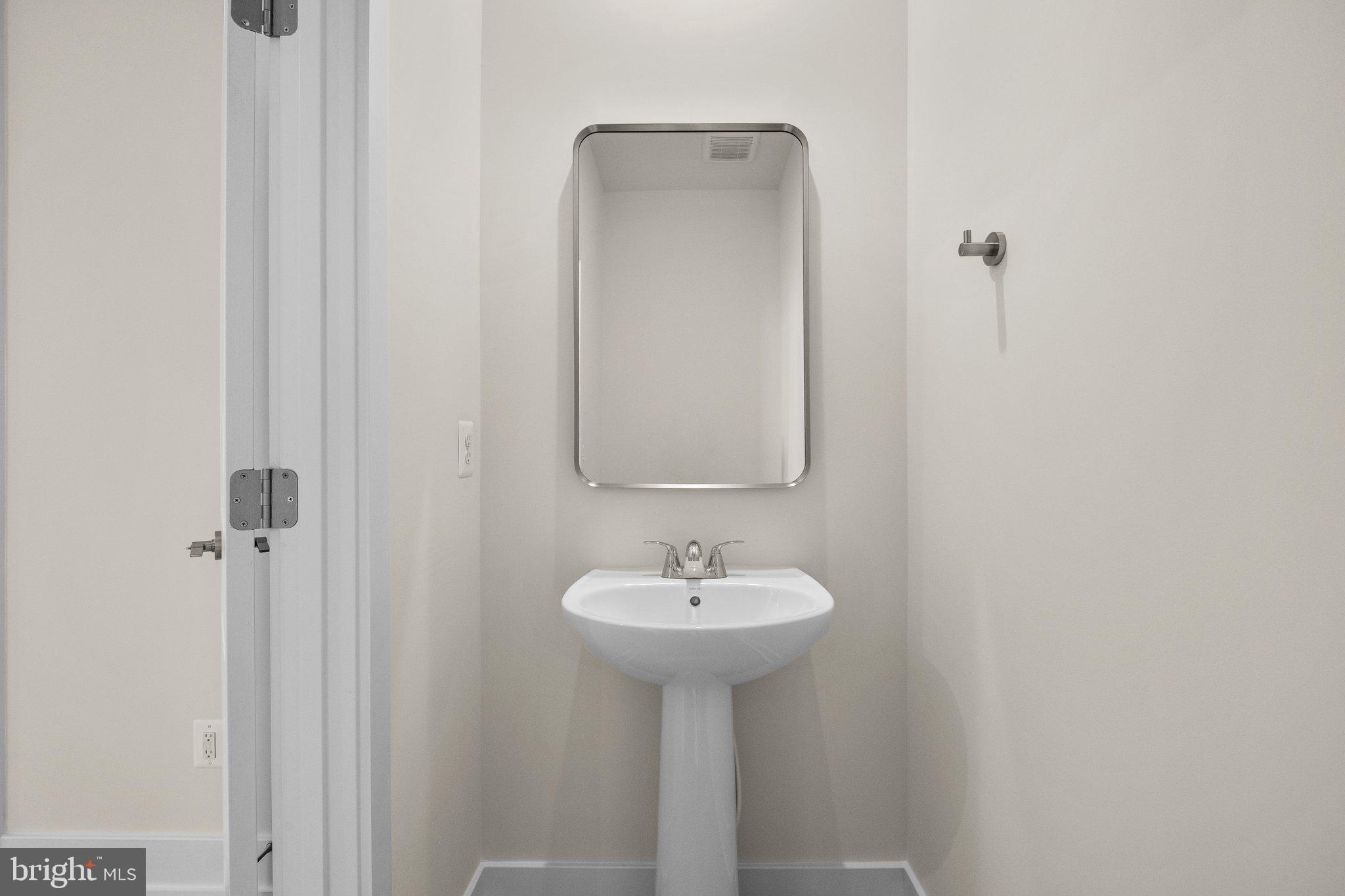 115 Galaxy Place Stephenson, VA 22656 - Photo 8 of 19 a bathroom with a sink a mirror and a shower