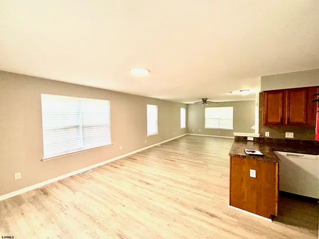 a view of a kitchen with a sink and cabinets