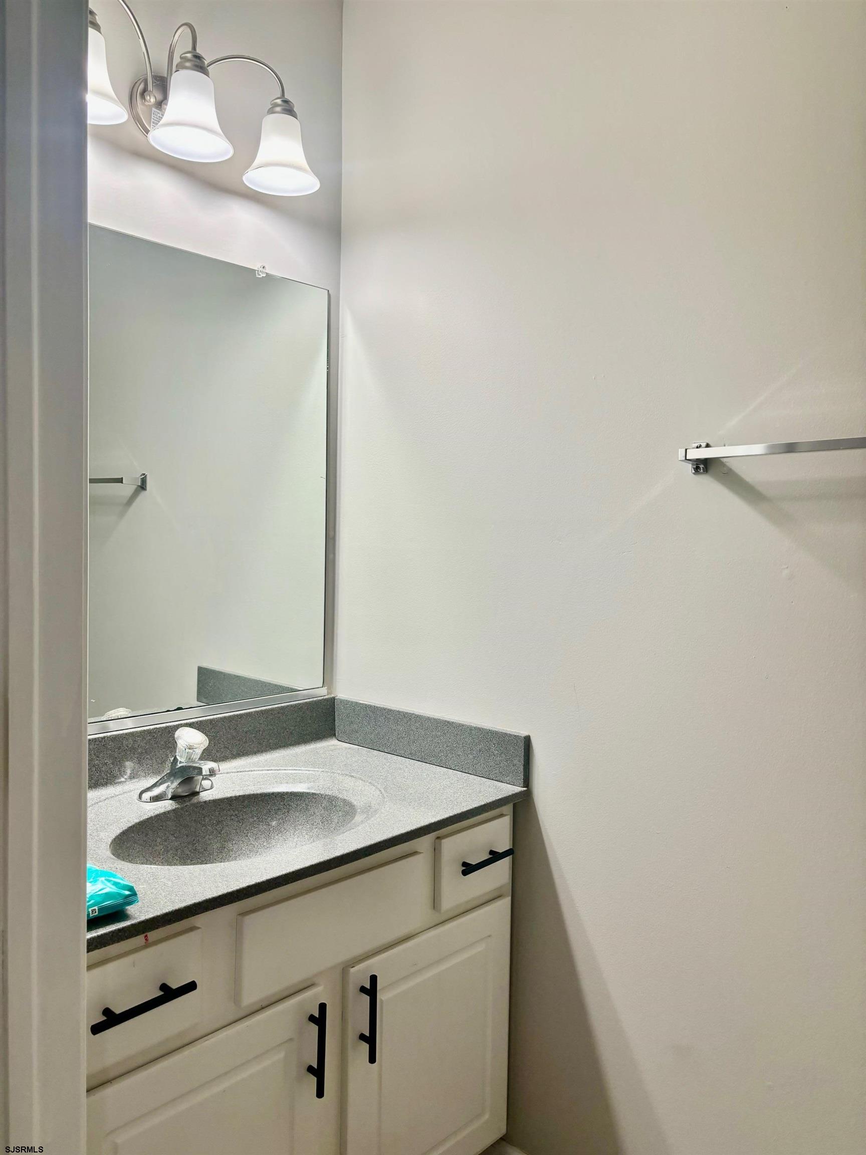 27 Oyster Bay, Unit G Absecon, NJ 08201 - Photo 14 of 31 a bathroom with a sink and a mirror
