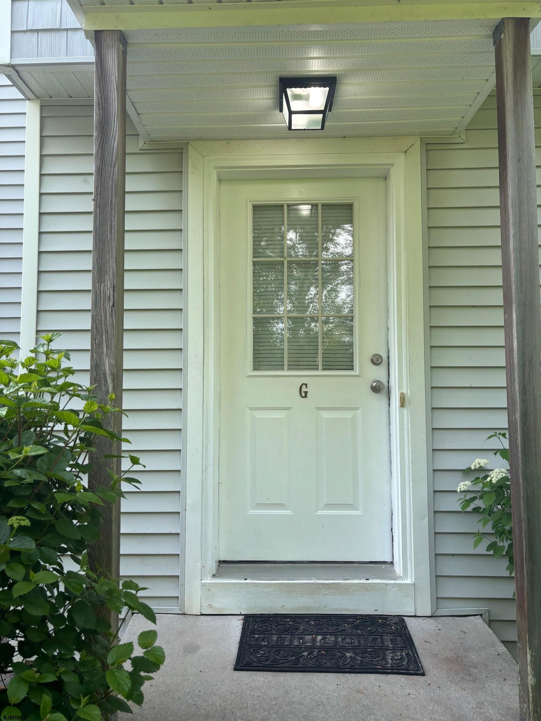 27 Oyster Bay, Unit G Absecon, NJ 08201 - Photo 2 of 31 a view of a entryway door of the house