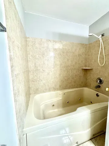 a bathroom with a bathtub and shower