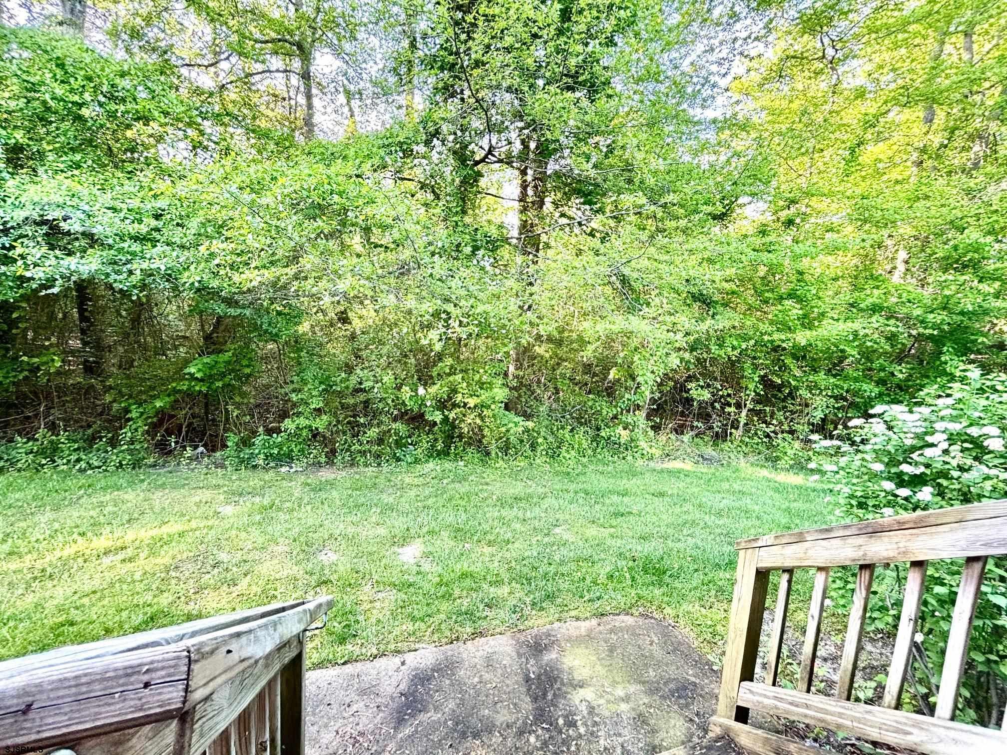 27 Oyster Bay, Unit G Absecon, NJ 08201 - Photo 28 of 31 a view of a yard with an outdoor seating and deck