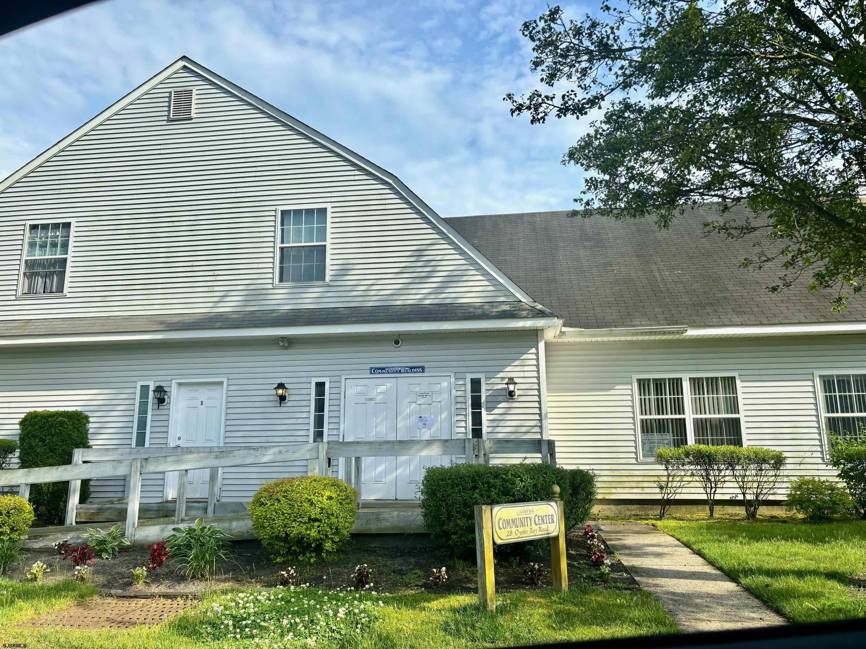 27 Oyster Bay, Unit G Absecon, NJ 08201 - Photo 29 of 31 a front view of a house with garden