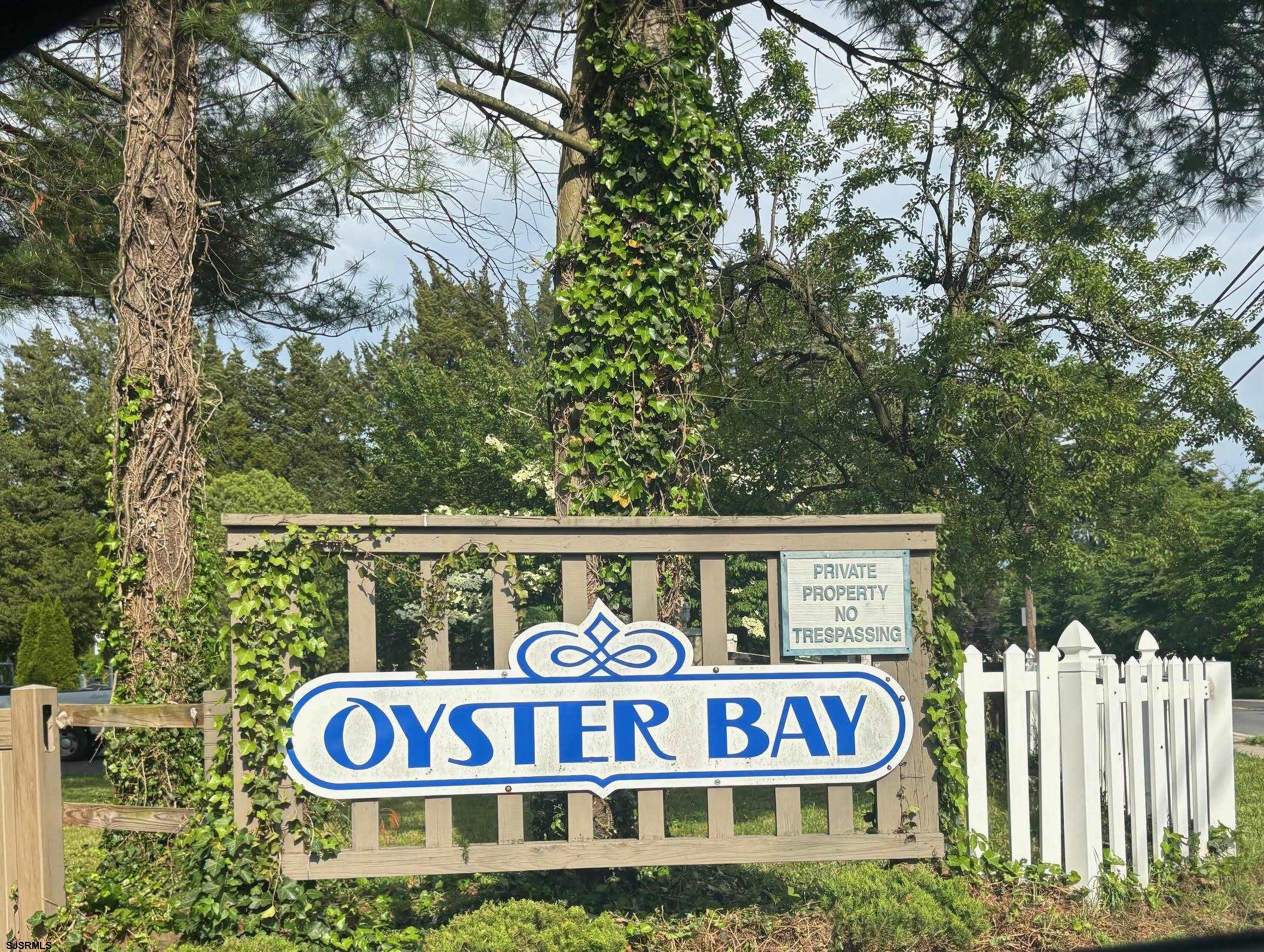 27 Oyster Bay, Unit G Absecon, NJ 08201 - Photo 4 of 31 a street sign on a pole on a street