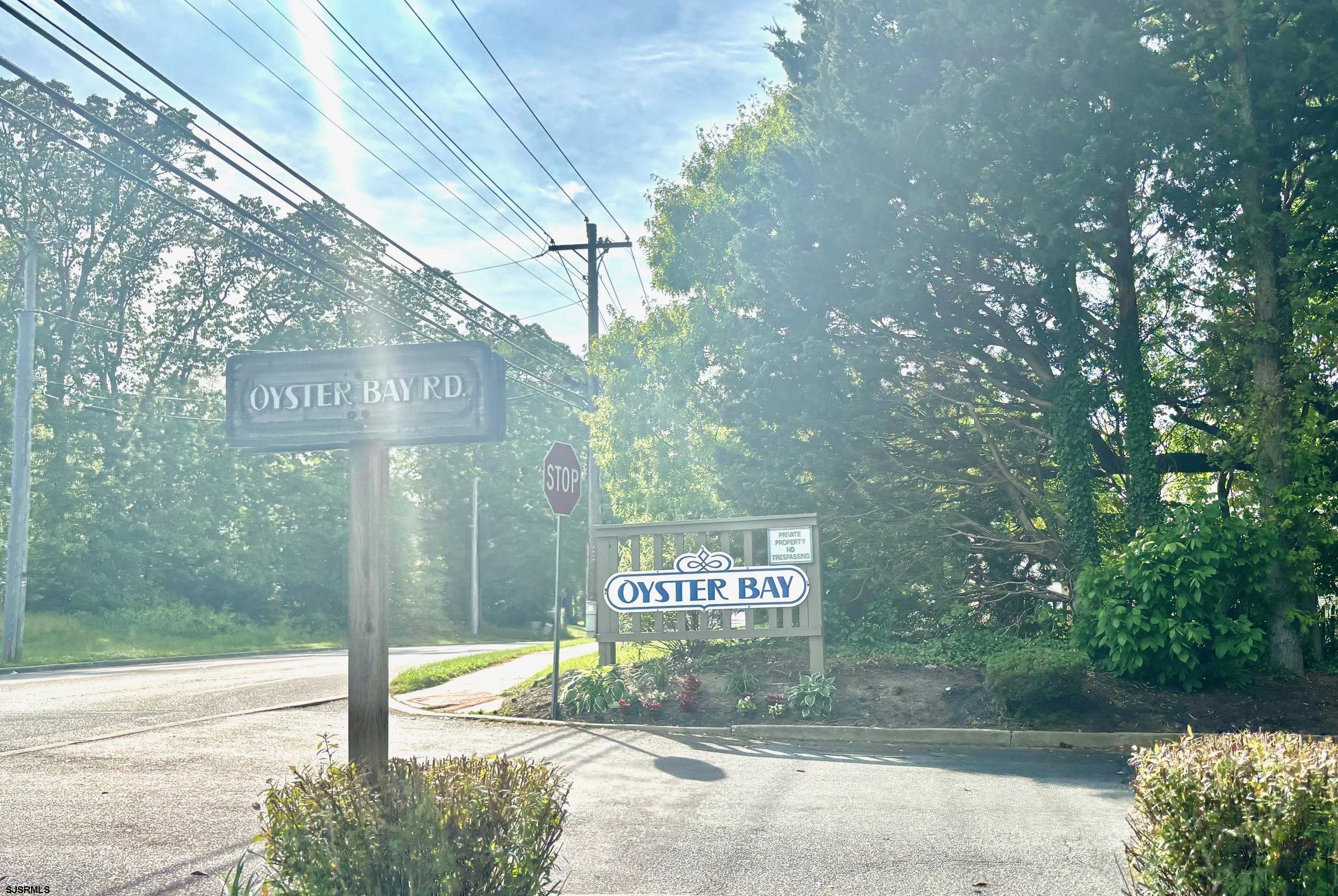 27 Oyster Bay, Unit G Absecon, NJ 08201 - Photo 5 of 31 a sign board with a yard