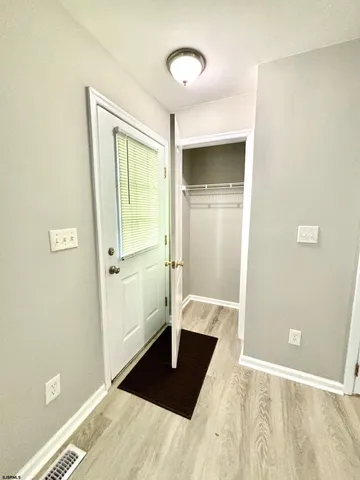 a view of a bedroom with wooden floor and bathroom