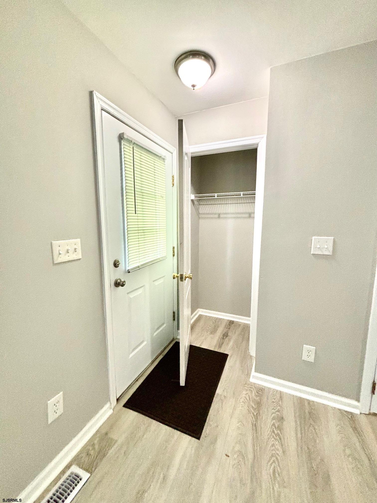 27 Oyster Bay, Unit G Absecon, NJ 08201 - Photo 7 of 31 a view of a bedroom with wooden floor and bathroom