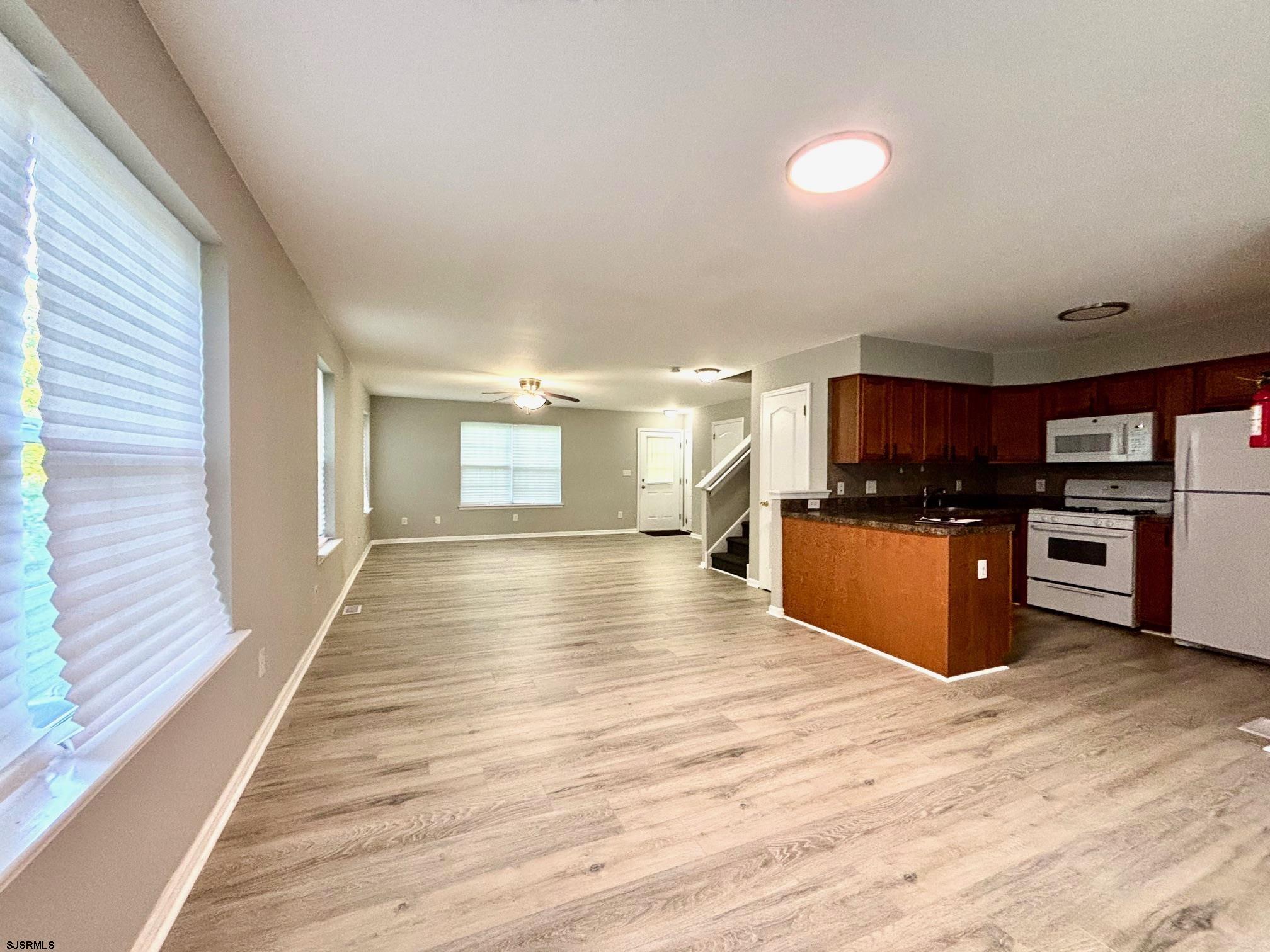 27 Oyster Bay, Unit G Absecon, NJ 08201 - Photo 9 of 31 a view of kitchen with kitchen island sink and wooden floor