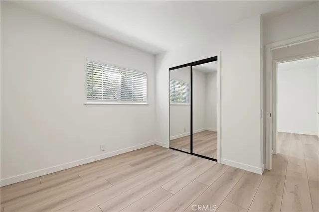 a view of an empty room with a ceiling fan