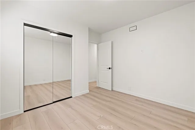 a patio with a table and chairs and couches with wooden roof and stairs