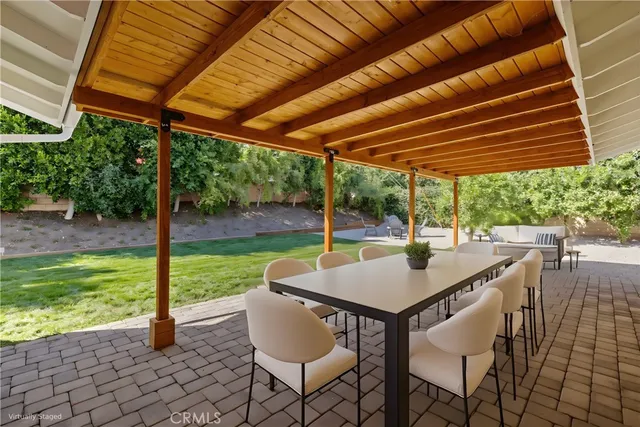a view of a backyard with plants and large trees