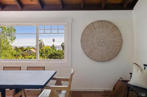 a living room with furniture flowerpot and window