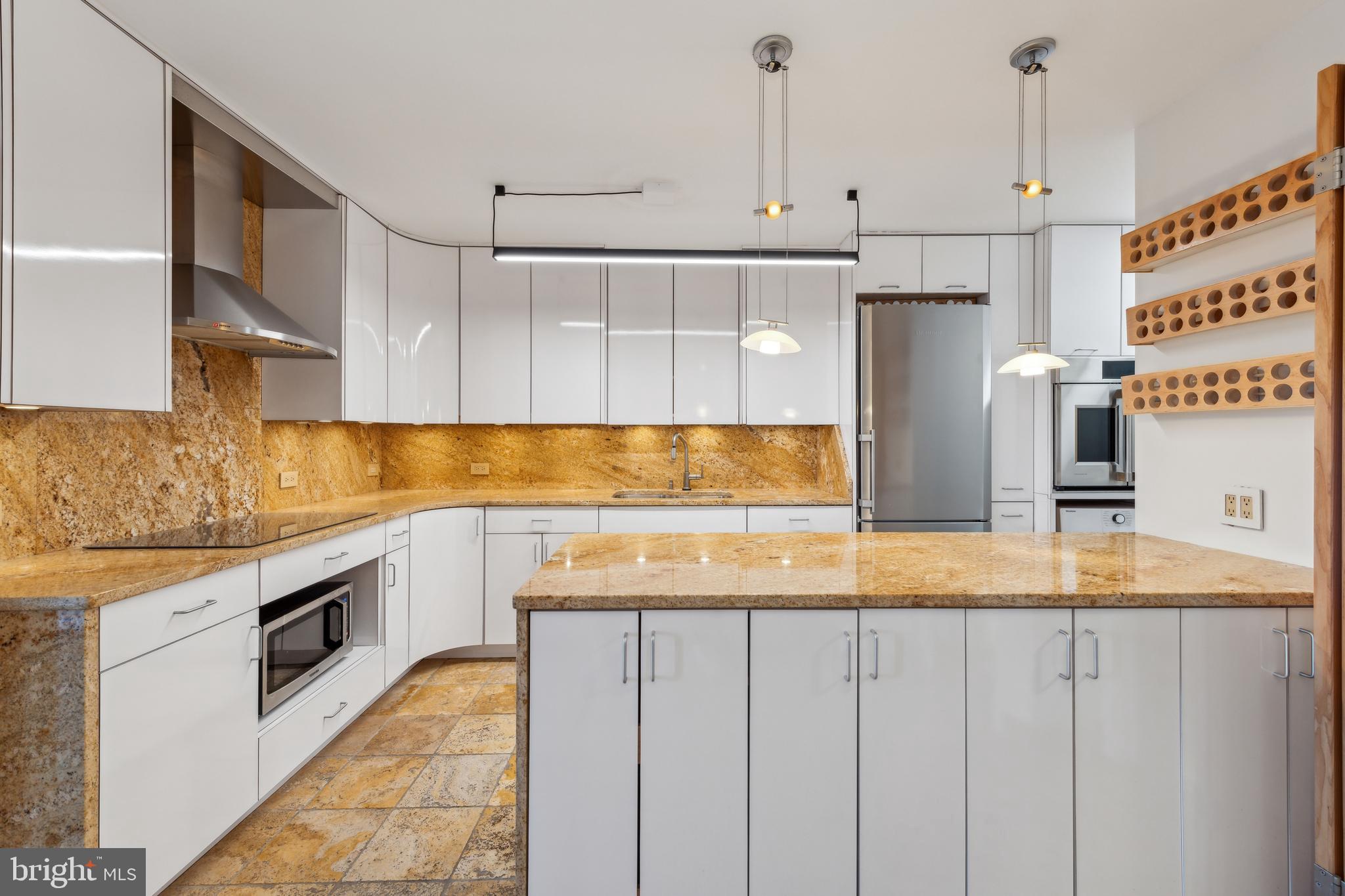 800 25th Street Northwest, Unit 605 Washington, DC 20037 - Photo 11 of 35 a kitchen with stainless steel appliances granite countertop a sink and a refrigerator