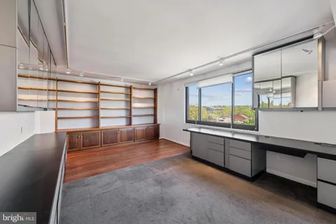 a view of room with window and wooden floor