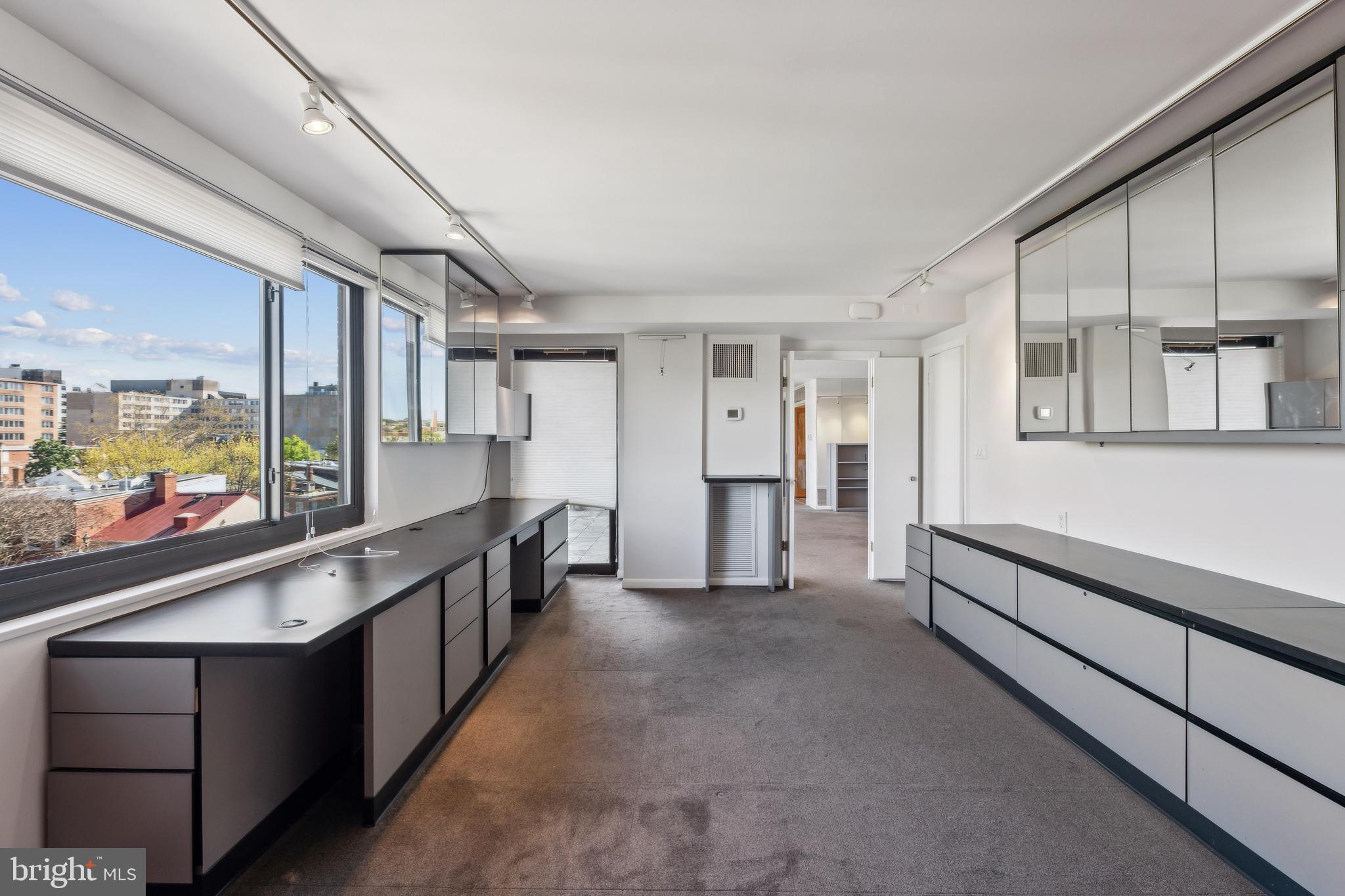 800 25th Street Northwest, Unit 605 Washington, DC 20037 - Photo 35 of 35 a large white kitchen with cabinets