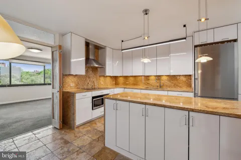 a kitchen with kitchen island a counter top space appliances and a counter top space