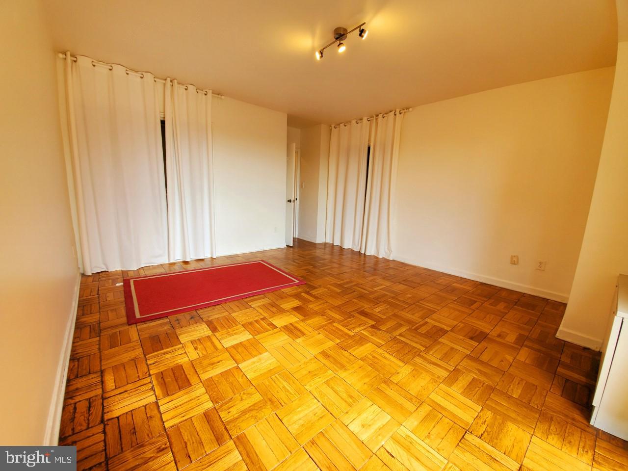 4301 Massachusetts Avenue Northwest, Unit 6007 Washington, DC 20016 - Photo 12 of 24 a bedroom with a bed and a mirror