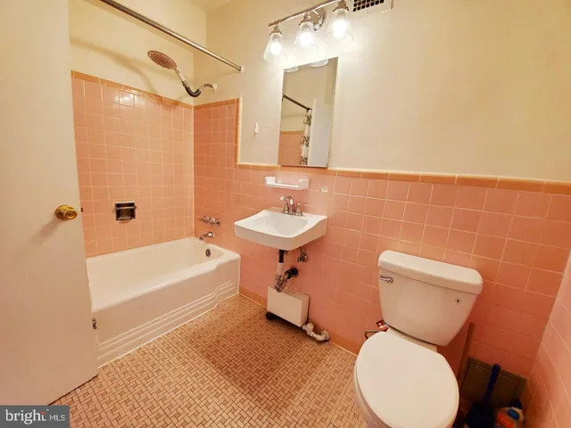 a bathroom with a sink mirror bathtub and toilet