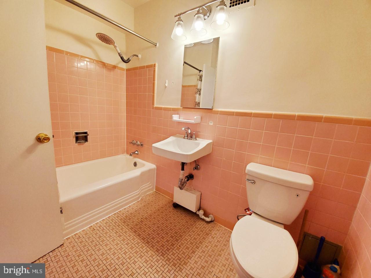 4301 Massachusetts Avenue Northwest, Unit 6007 Washington, DC 20016 - Photo 13 of 24 a bathroom with a sink mirror bathtub and toilet