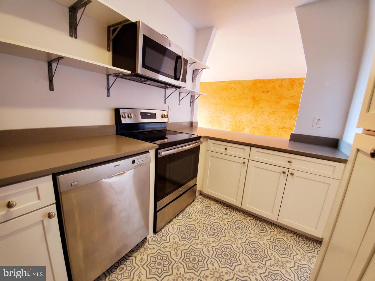 4301 Massachusetts Avenue Northwest, Unit 6007 Washington, DC 20016 - Photo 7 of 24 a kitchen with stainless steel appliances white cabinets and a sink