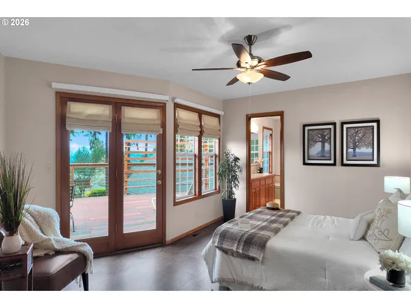 a bedroom with a large bed and a large window