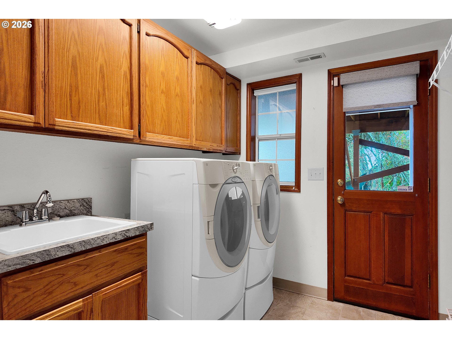 3023 Ashley Loop Eugene, OR 97405 - Photo 28 of 48 a utility room with sink dryer and washer