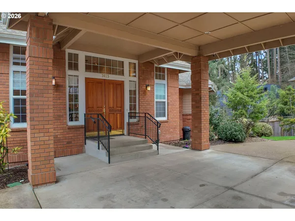 a view of a house with backyard porch and sitting area