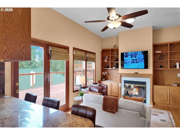 a living room with furniture large window and a fireplace