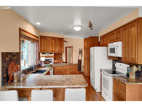 a kitchen with refrigerator cabinets and wooden floor