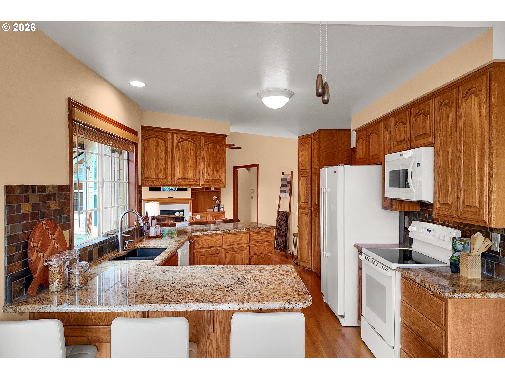 3023 Ashley Loop Eugene, OR 97405 - Photo 8 of 48 a kitchen with refrigerator cabinets and wooden floor