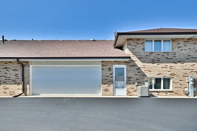 a front view of a house with a garage