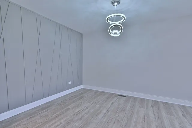 a view of a storage and utility room with wooden floor