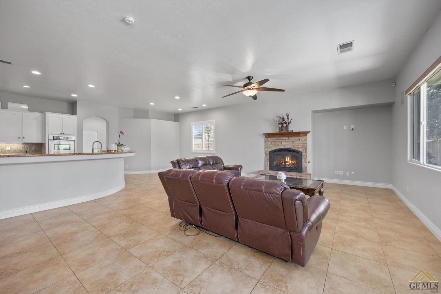 Undisclosed Address Bakersfield, CA 93311 - Photo 20 of 57 a living room with furniture and a fireplace