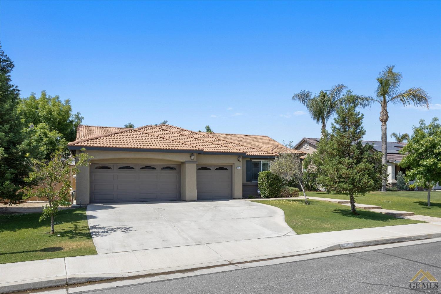 Undisclosed Address Bakersfield, CA 93311 - Photo 3 of 57 a front view of a house with a yard and garage