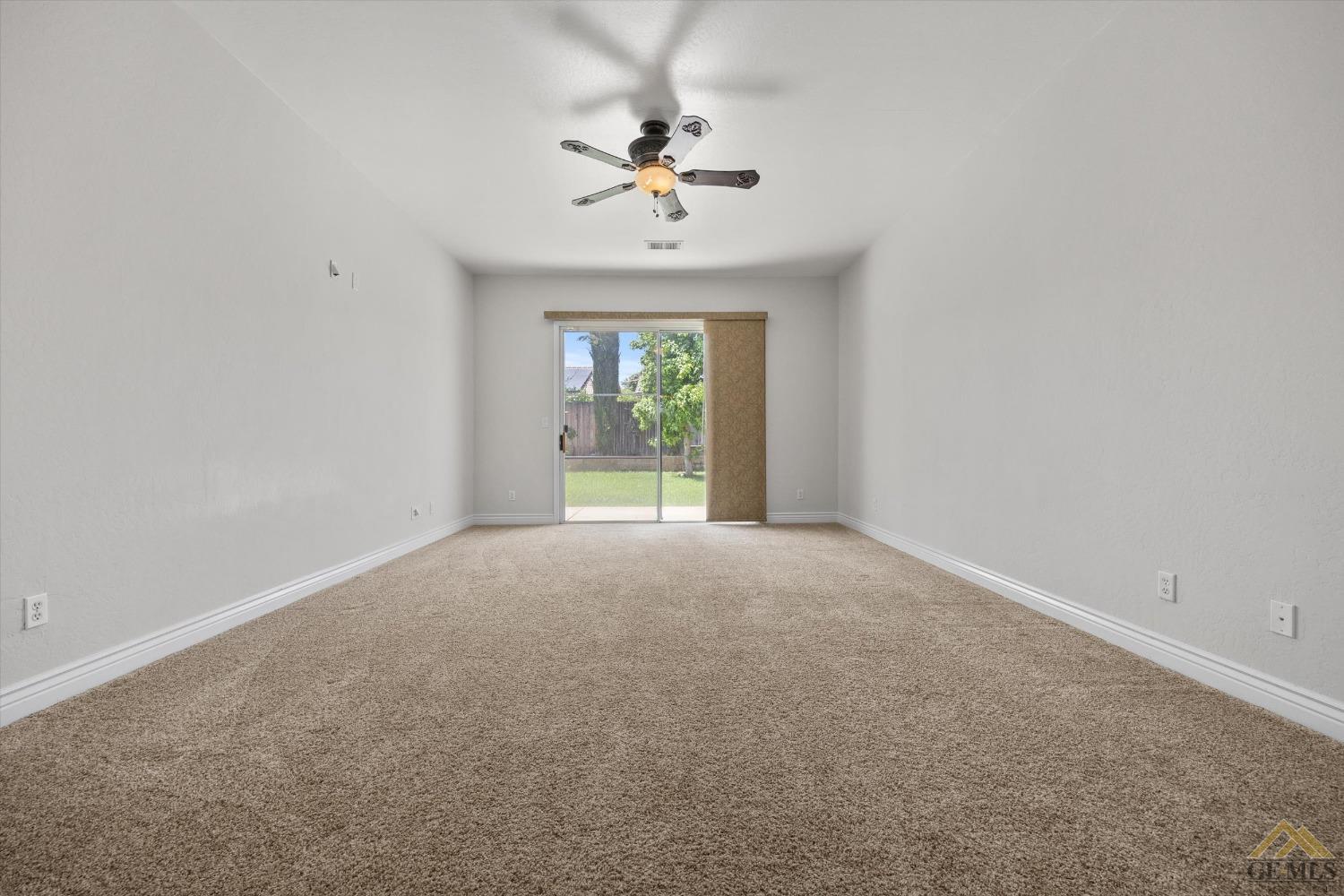 Undisclosed Address Bakersfield, CA 93311 - Photo 33 of 57 an empty room with a window and a ceiling fan